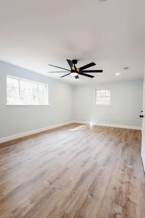 a view of a room with wooden floor and window