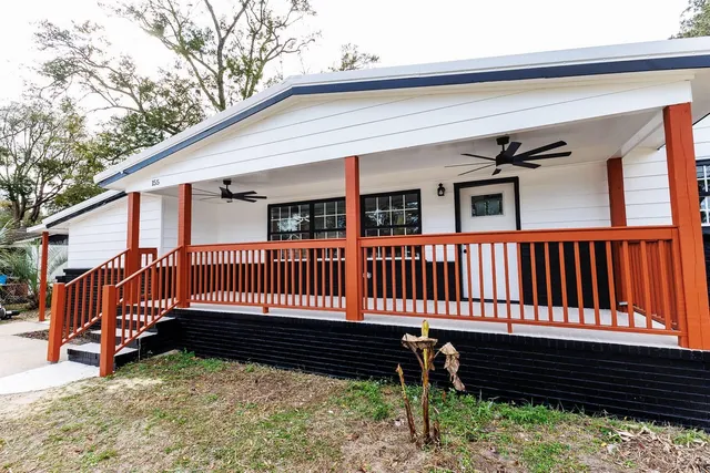 a view of a deck with wooden floor and fence