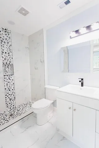 a bathroom with a sink toilet and shower