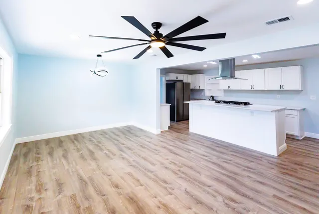 a view of kitchen with cabinets and wooden floor