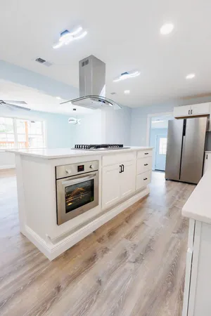 a kitchen with stainless steel appliances a stove top oven and a refrigerator