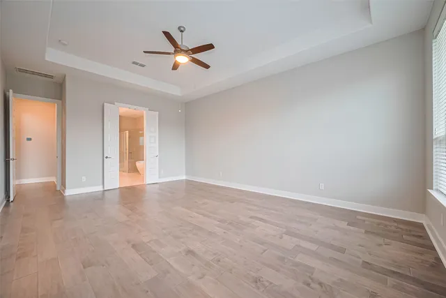a view of an empty room and wooden floor