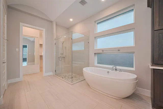a bathroom with a bathtub and shower