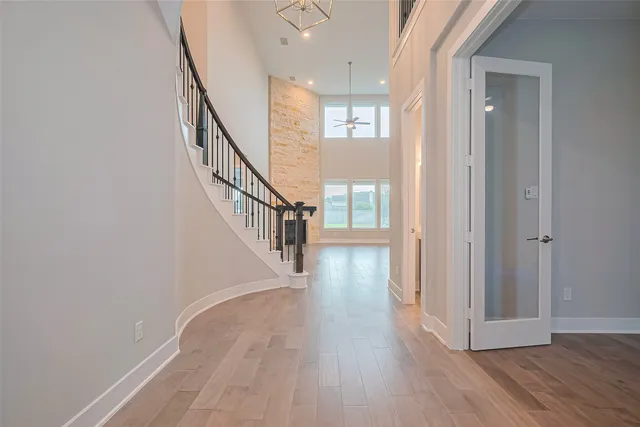 a view of a hallway with wooden floor and entryway