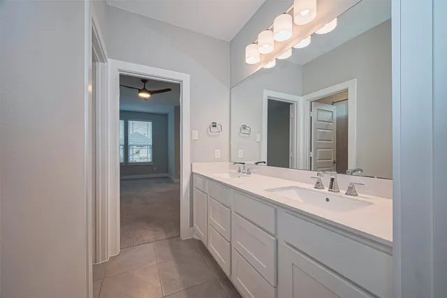 a bathroom with a double vanity sink and a mirror
