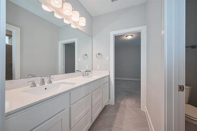 a bathroom with a double vanity sink and a mirror