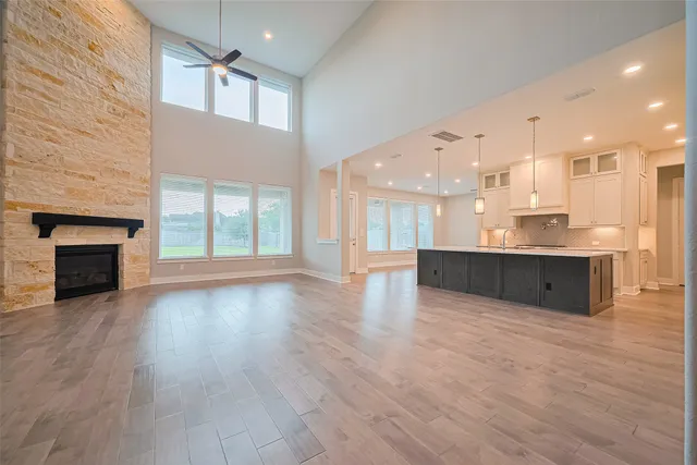 an empty room with wooden floor and fireplace
