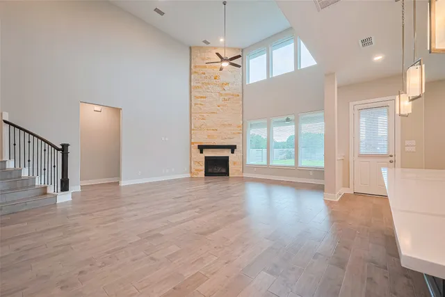 a view of a livingroom with wooden floor and a fireplace