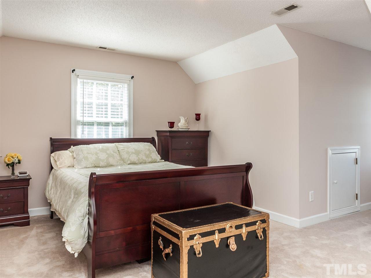 3128 Sanders Road Willow Spring, NC 27592 - Photo 11 of 25 a bedroom with a bed and a window