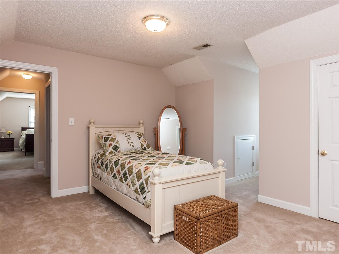 3128 Sanders Road Willow Spring, NC 27592 - Photo 12 of 25 a bedroom with a bed and a couch