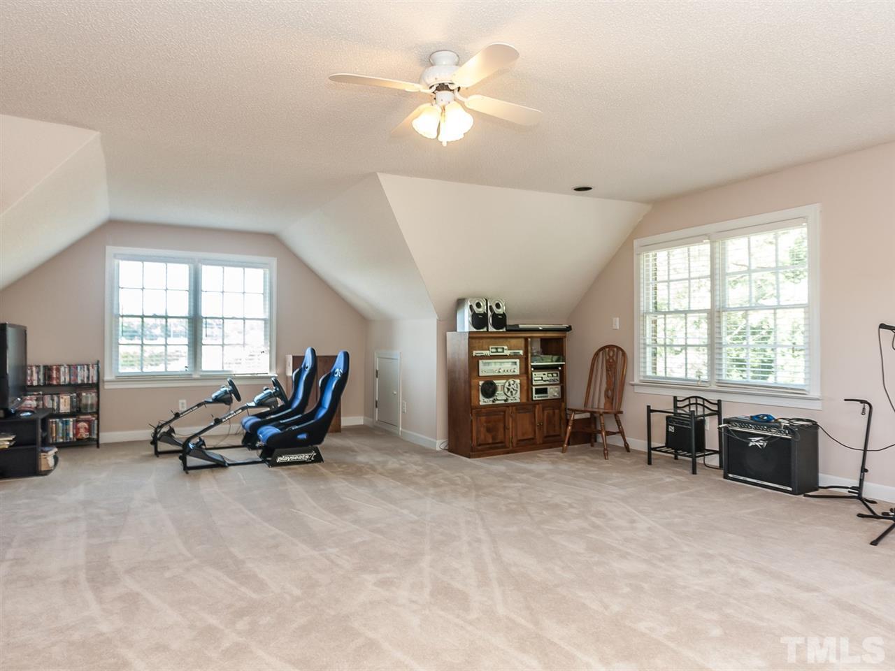 3128 Sanders Road Willow Spring, NC 27592 - Photo 13 of 25 a living room with furniture cabinets and a window