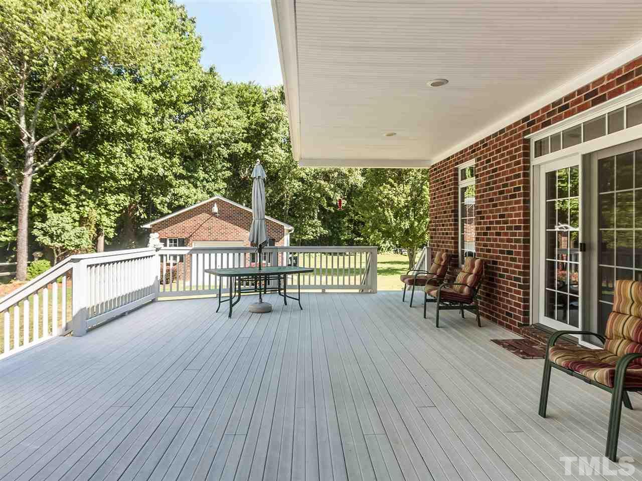 3128 Sanders Road Willow Spring, NC 27592 - Photo 14 of 25 a view of a chairs and table on the wooden deck