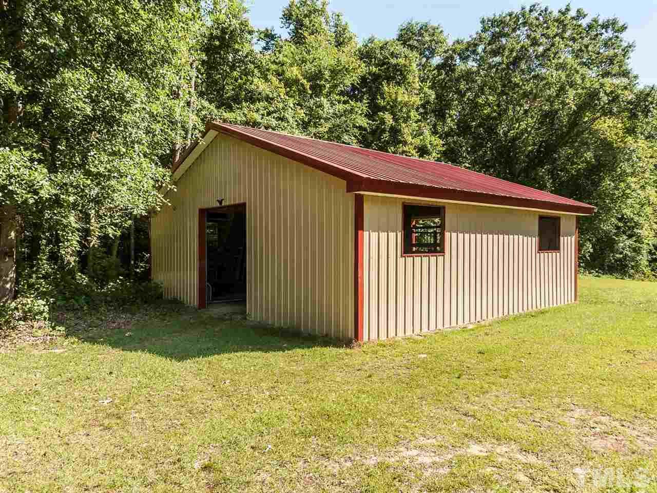 3128 Sanders Road Willow Spring, NC 27592 - Photo 16 of 25 a view of a backyard with a garden