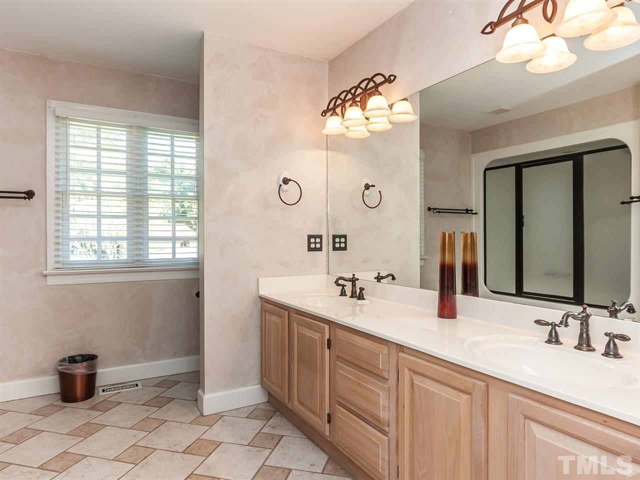 3128 Sanders Road Willow Spring, NC 27592 - Photo 9 of 25 a bathroom with a double vanity sink mirror and