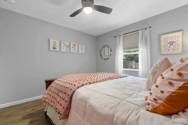 a bedroom with a large bed and a window