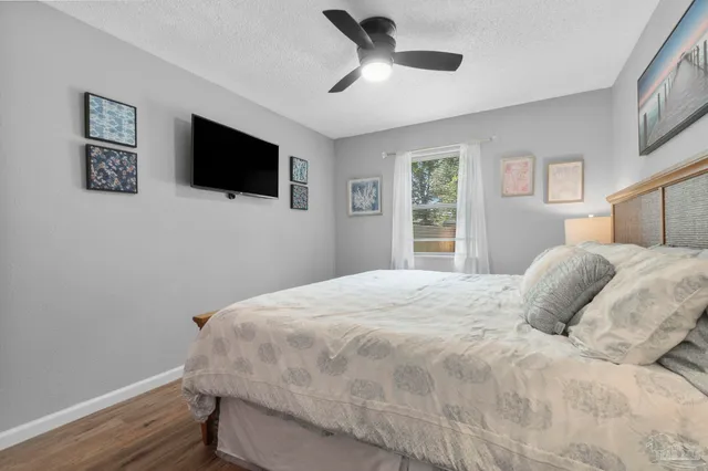 a bedroom with a large bed and a flat screen tv