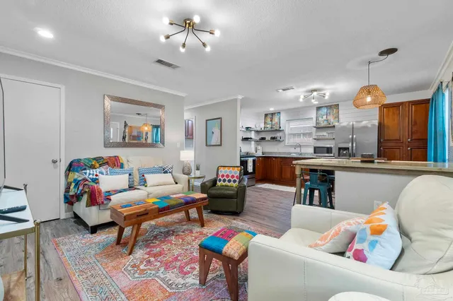 a living room with furniture and a kitchen view