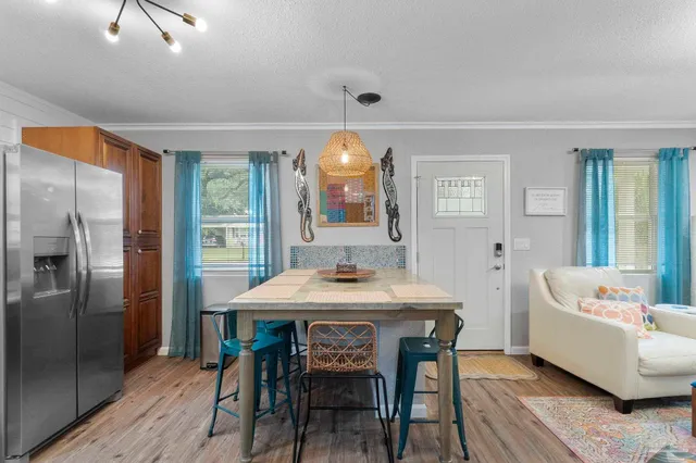 a view of a dining room with furniture and window
