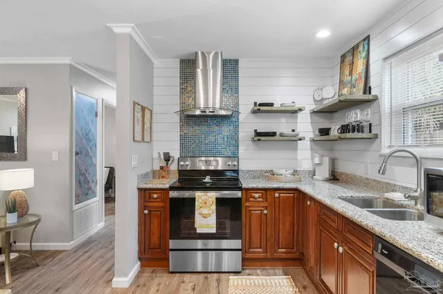 a kitchen with stainless steel appliances granite countertop a sink stove and refrigerator