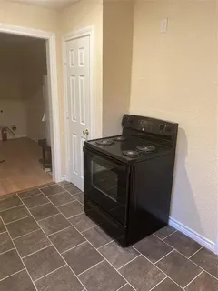 a stove top oven sitting inside of a kitchen