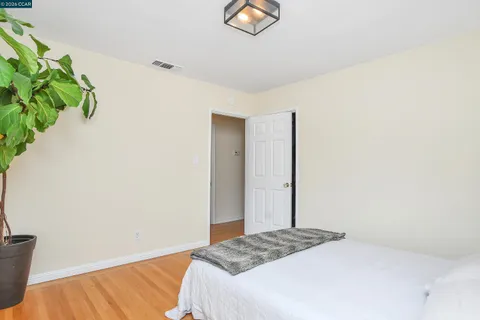 a bedroom with a bed and a potted plant