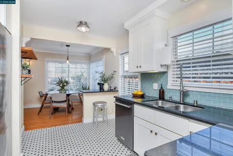 a kitchen with a sink a counter top space and appliances