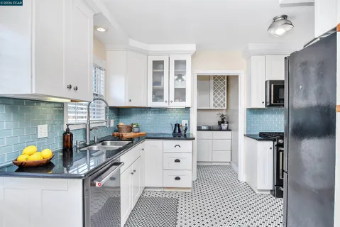 a kitchen with a sink appliances and cabinets