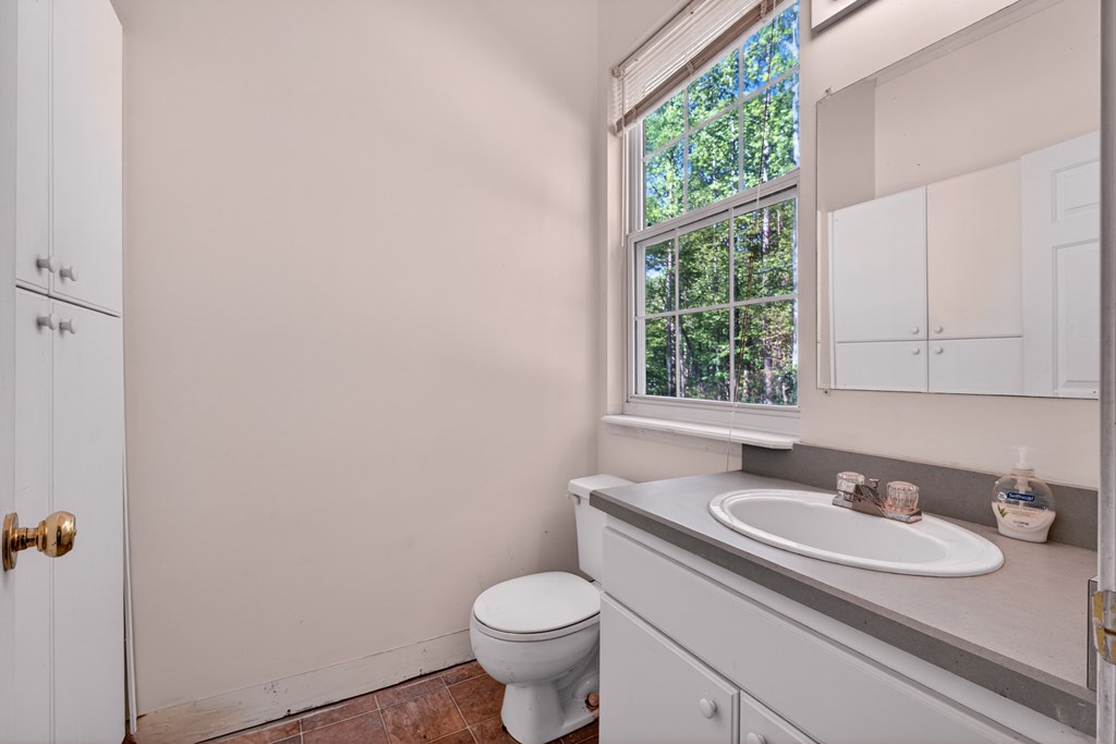 282 West Cherry Road Hayesville, NC 28904 - Photo 19 of 45 a bathroom with a granite countertop sink and a toilet