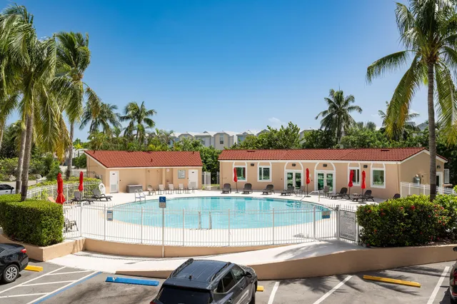 a view of a house with a swimming pool and sitting area