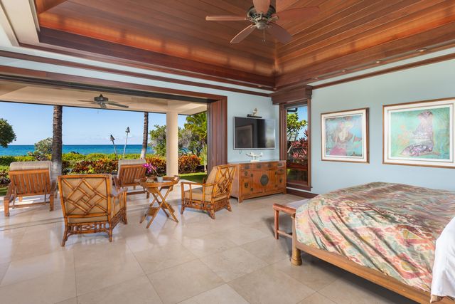 a bedroom with furniture and a large window