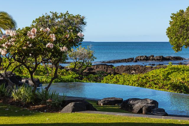 a view of a two chair and a table in a garden