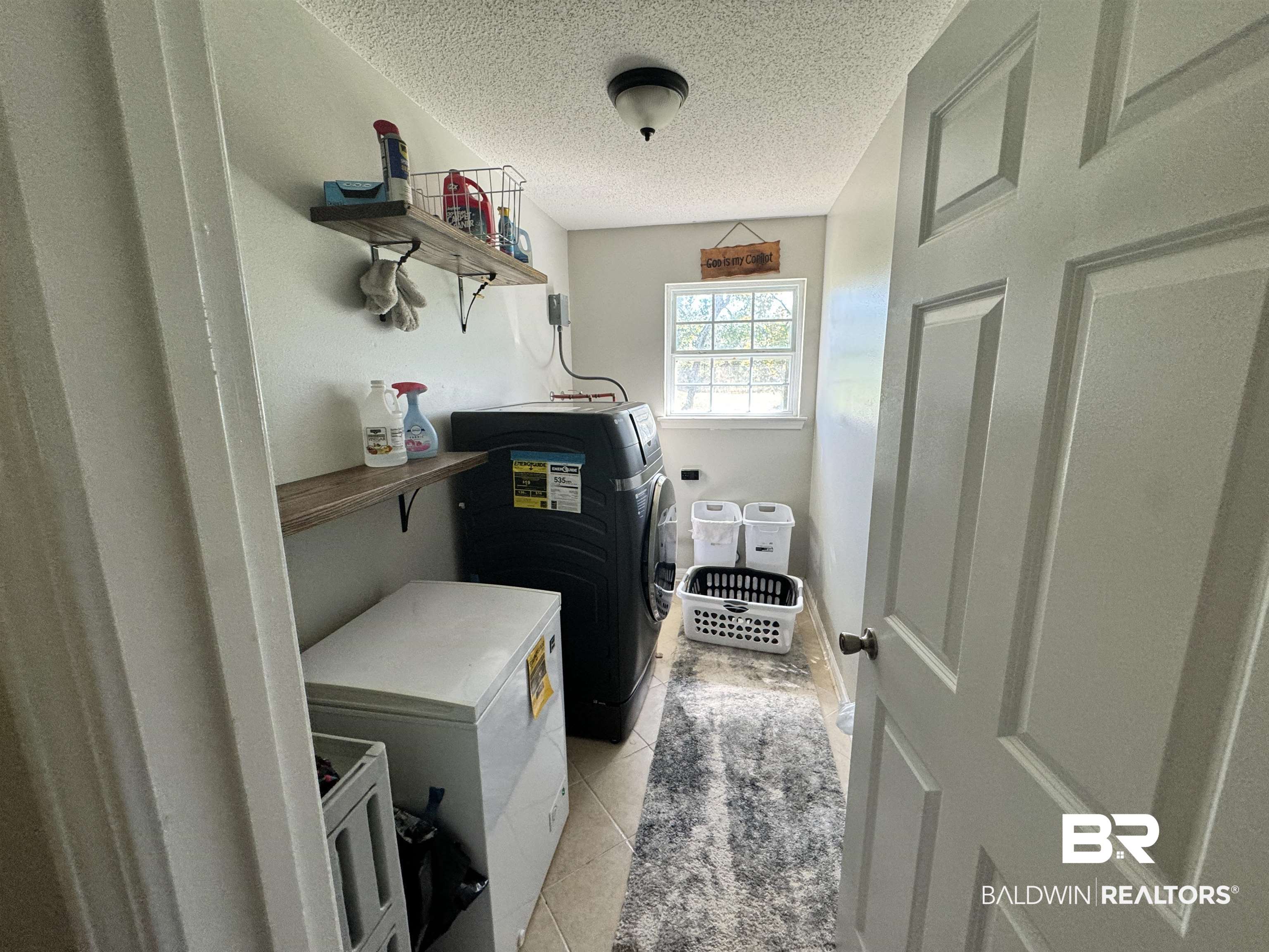 14313 Hemley Road Coden, AL 36523 - Photo 12 of 44 Washroom featuring a textured ceiling, light tile patterned flooring, and washing machine and clothes dryer