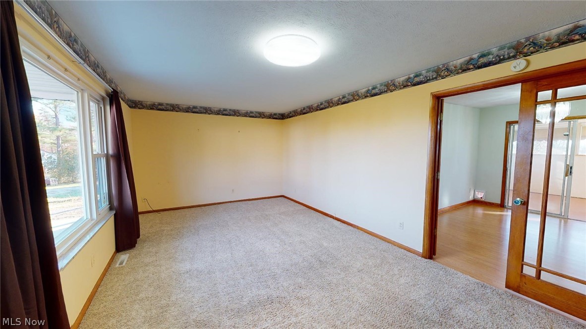 1420 Spider Ridge Road Parkersburg, WV 26104 - Photo 9 of 25 Living room looking through glass doors toward dining room then through sliding doors to enclosed porch.