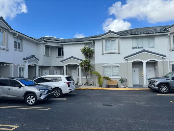 a view of a car parked in front of white house