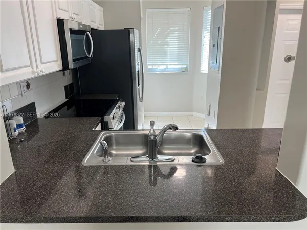 a view of a hallway with a chandelier