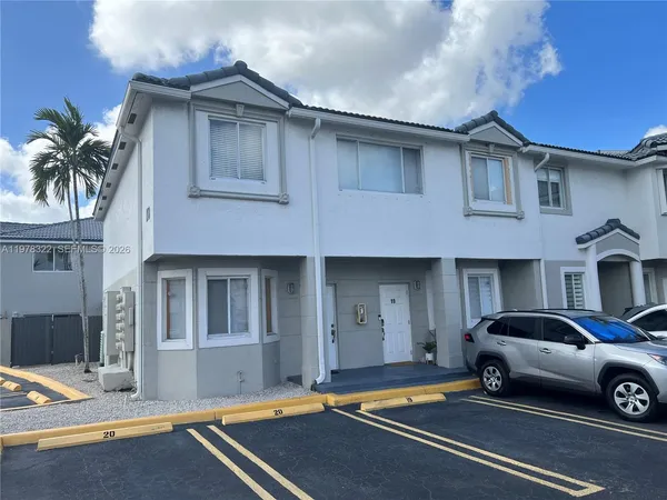 a front view of a house with parking space