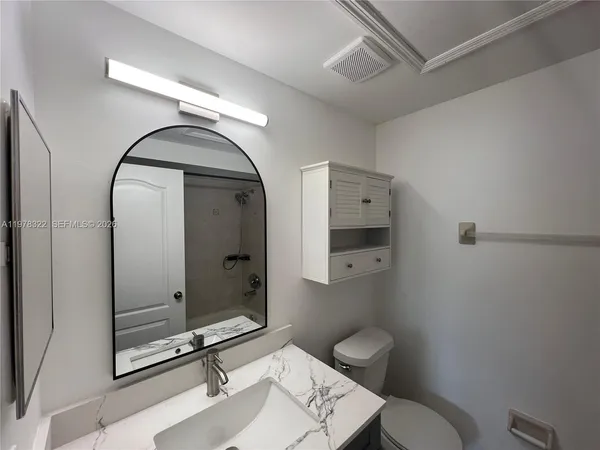 a view of a room with wooden floor and a window