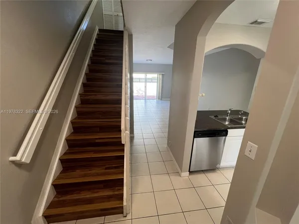 a view of entryway and hall with wooden floor