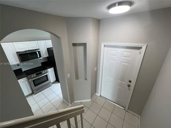 a view of a kitchen from the hallway