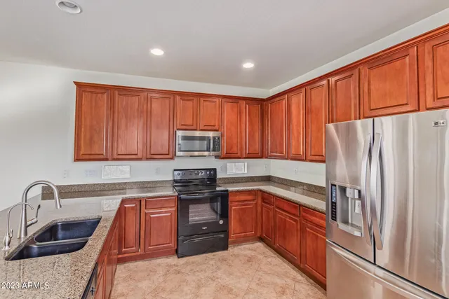 a kitchen with a sink and a refrigerator