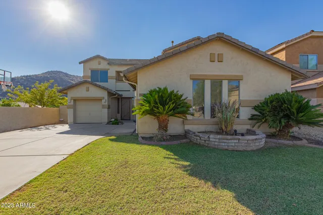 a front view of a house with a garden and plants
