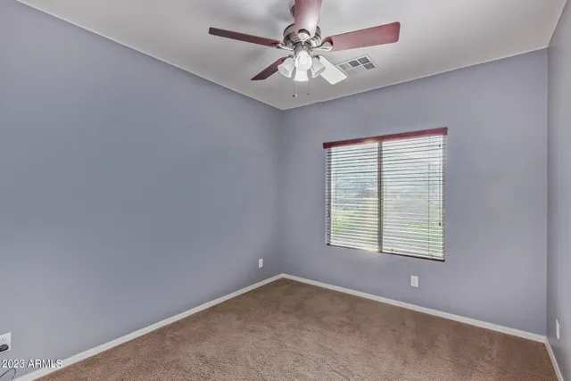 a view of a hallway with a ceiling fan