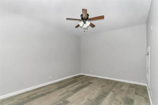 a view of a room with wooden floor and fan