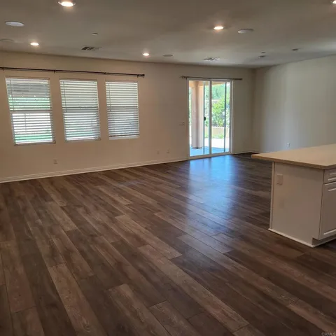 a kitchen with granite countertop a stove and a refrigerator