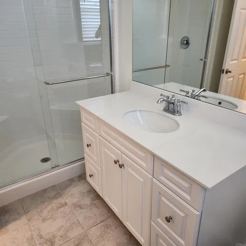a view of staircase with wooden floor and white walls