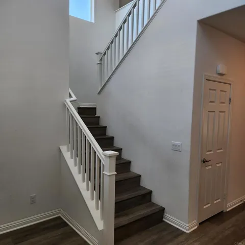 a view of a room with wooden floor and window