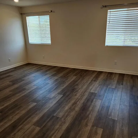 a view of a room with wooden floor and cabinet