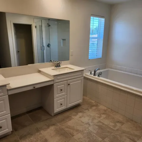 a bathroom with a bathtub and a shower