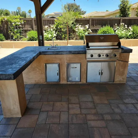 a view of a street with a bench and table in the patio