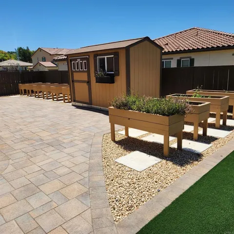 a view of a house with backyard and sitting area